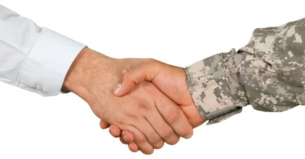 A group of veterans shaking hands with members of your company